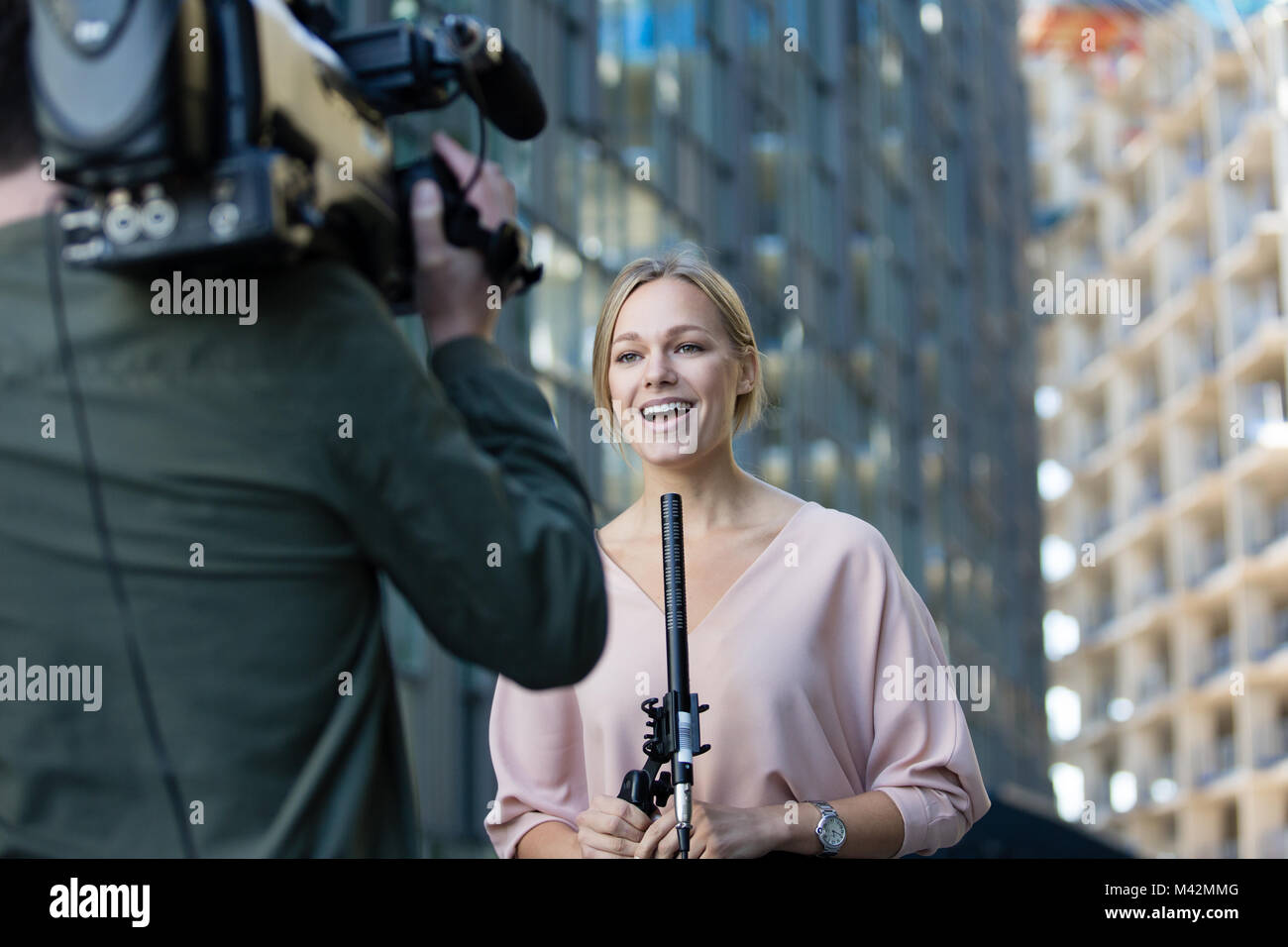 Female news presenter talking to camera Stock Photo