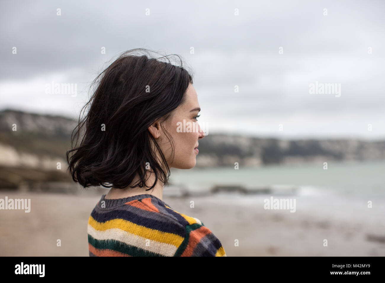 Young female looking at sea thoughtfully Stock Photo