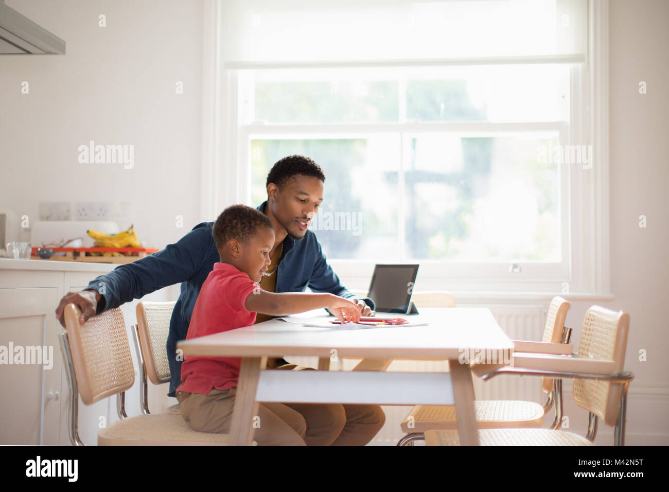 Father helping Son with school work Stock Photo