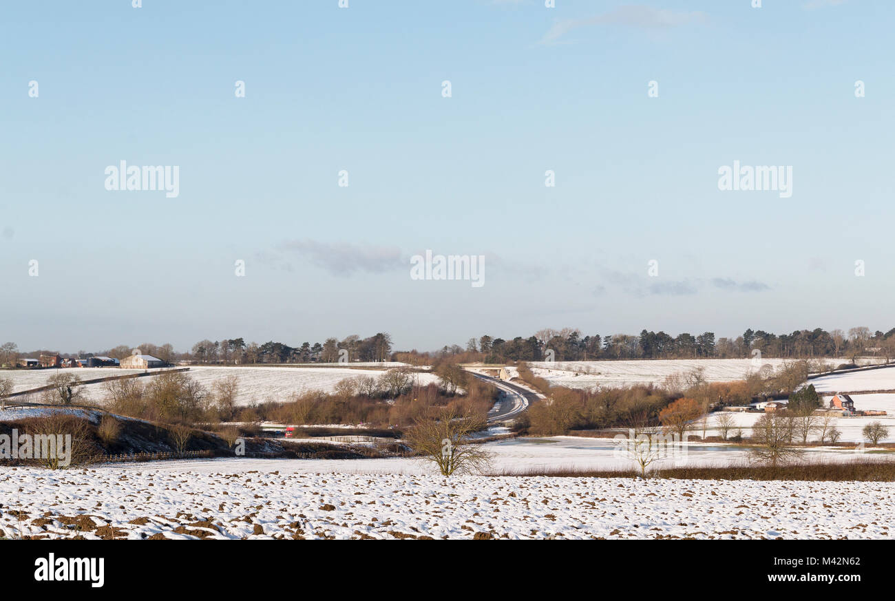 An image of farmland covered in snow, taken on a cold winters morning, near Kibworth Harcourt, Leicestershire, England, UK Stock Photo