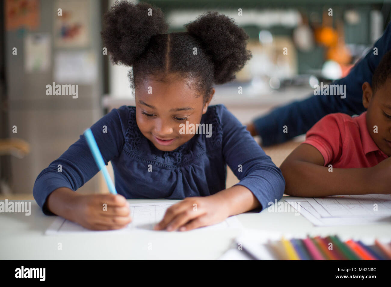 African American girl doing school work at home Stock Photo