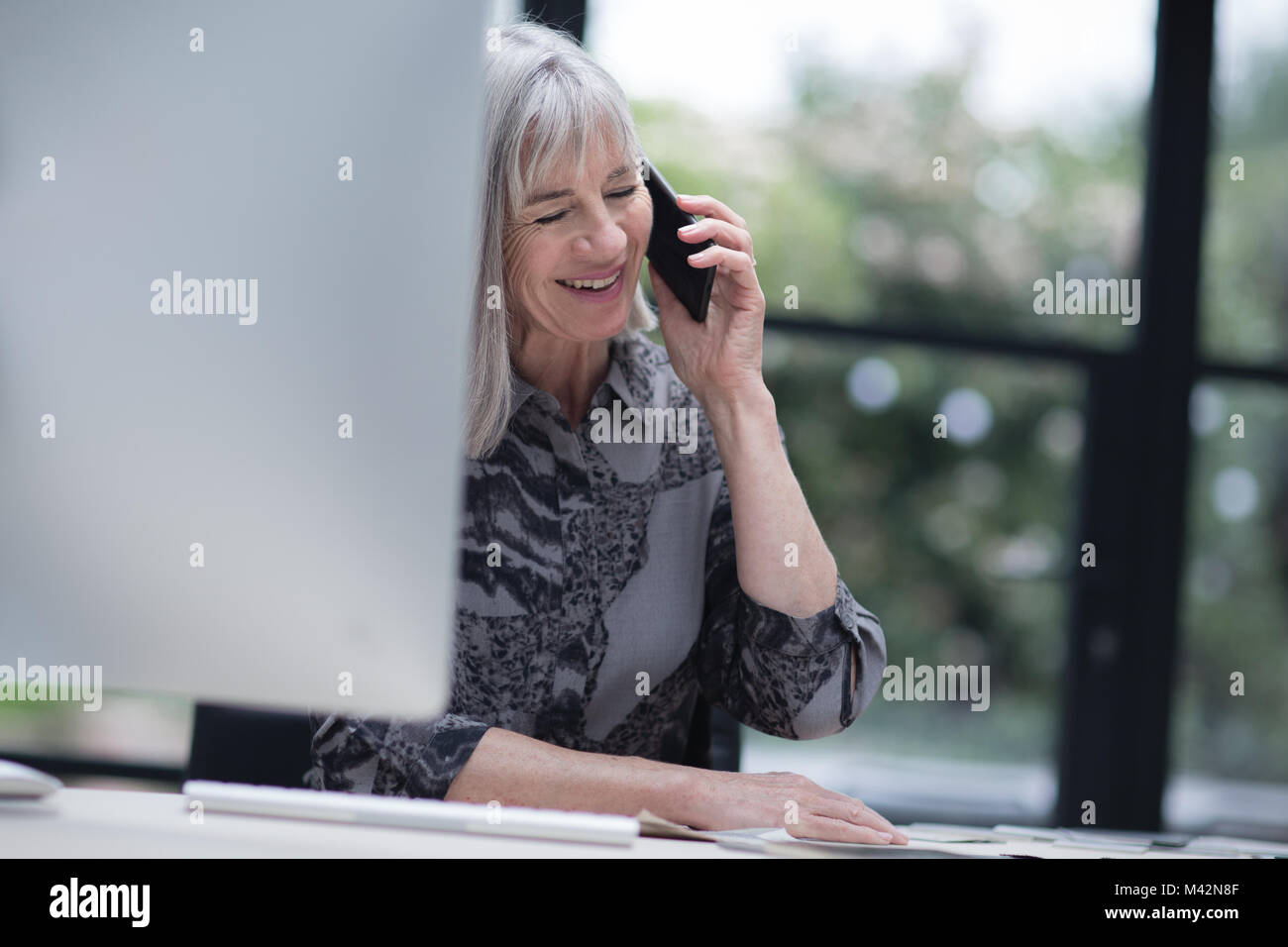 Senior businesswoman working in office Stock Photo