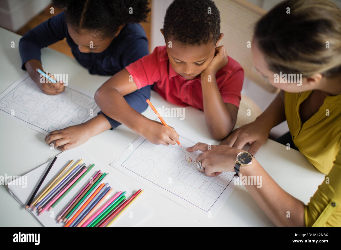 Children learning how to write alphabet Stock Photo