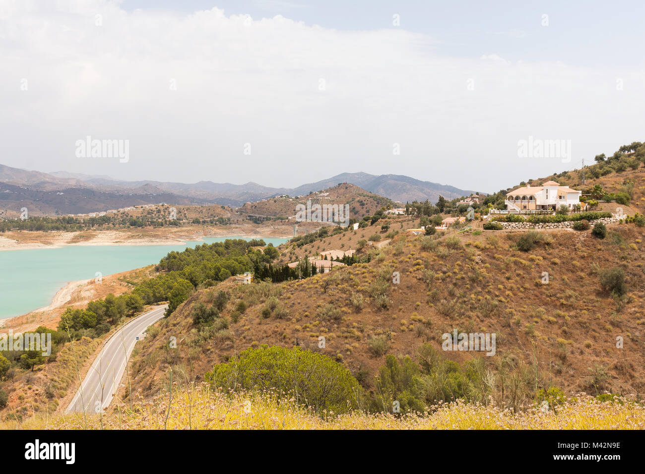 An image of villas on the hillside overlooking Lake Vinuela in the Province of Malaga, Andalusia, Spain, Europe Stock Photo