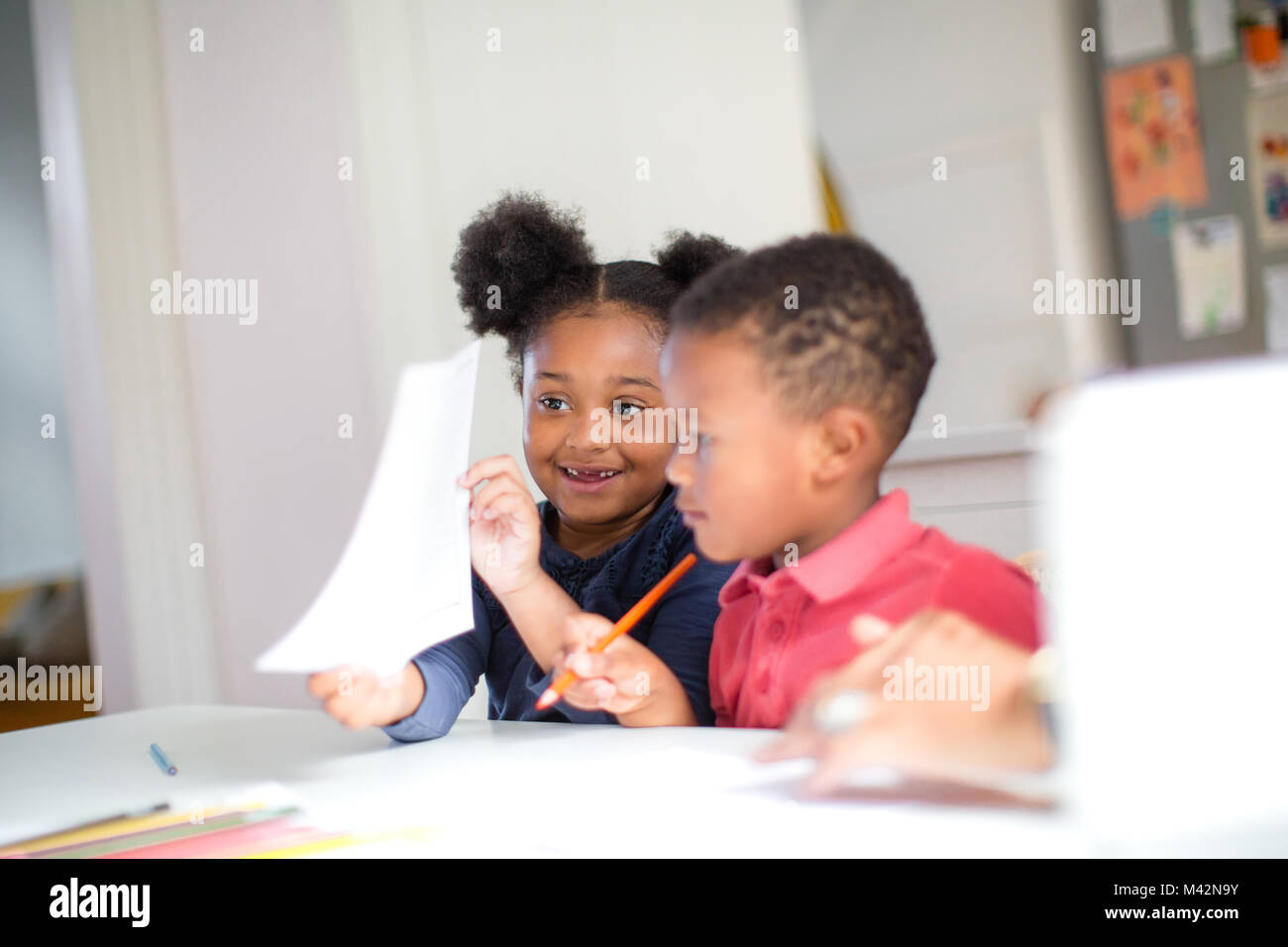 African American holding up school work proudly Stock Photo