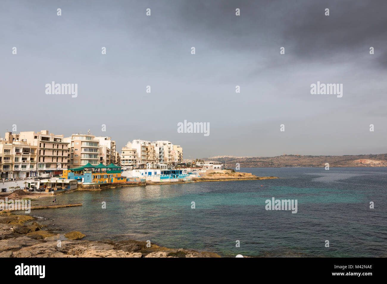 An image of St. Paul's bay and the surrounding buildings, Qawra, Malta taken on a Spring day. Stock Photo