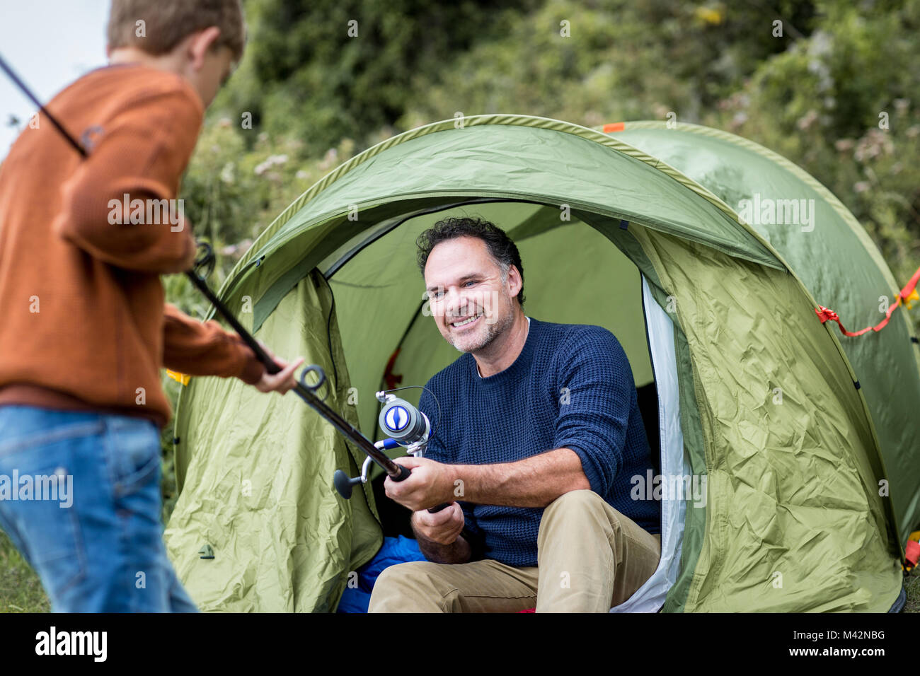 Father teaching Son how to fish Stock Photo - Alamy