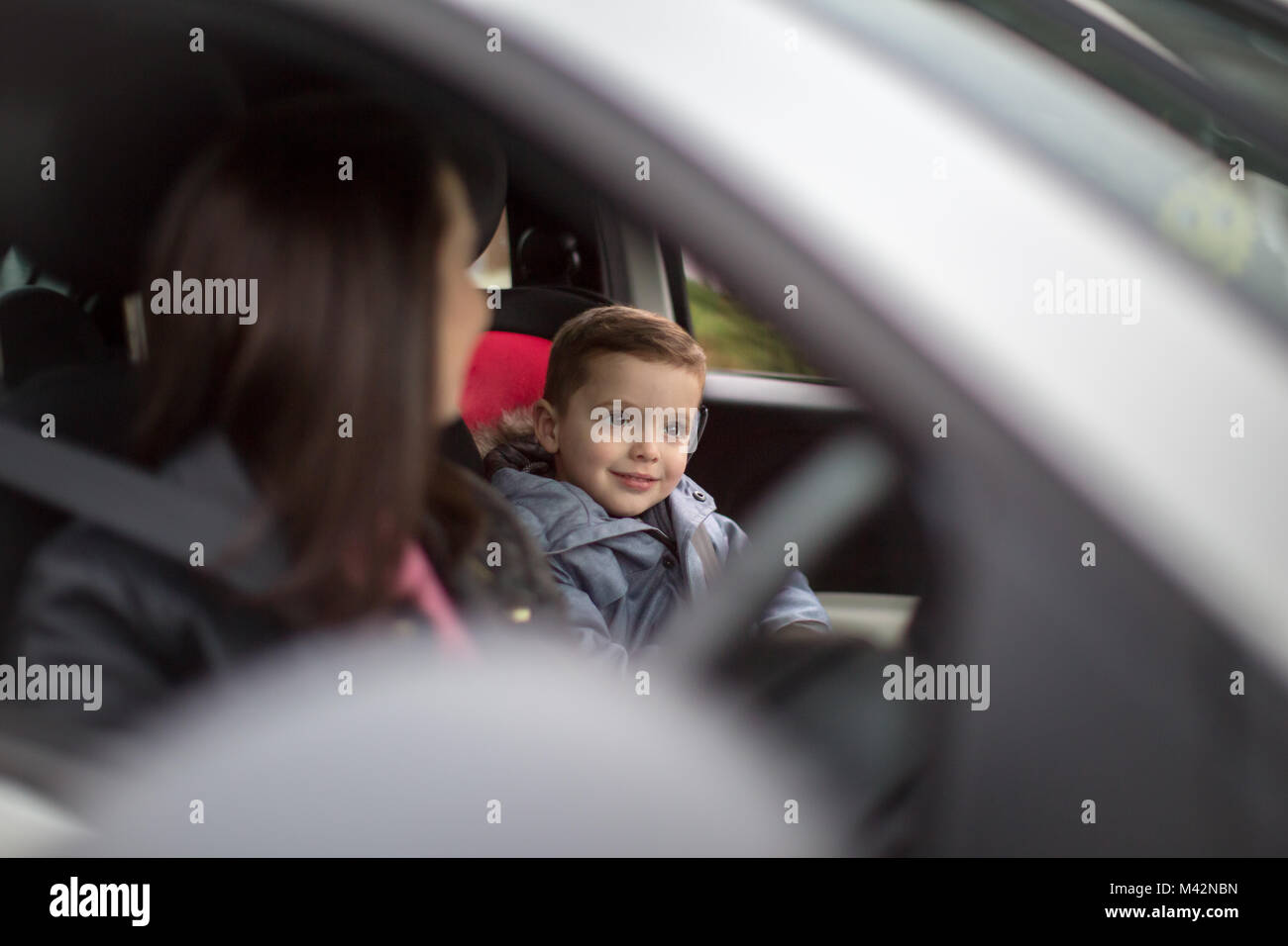 Boy smiling on car road trip Stock Photo