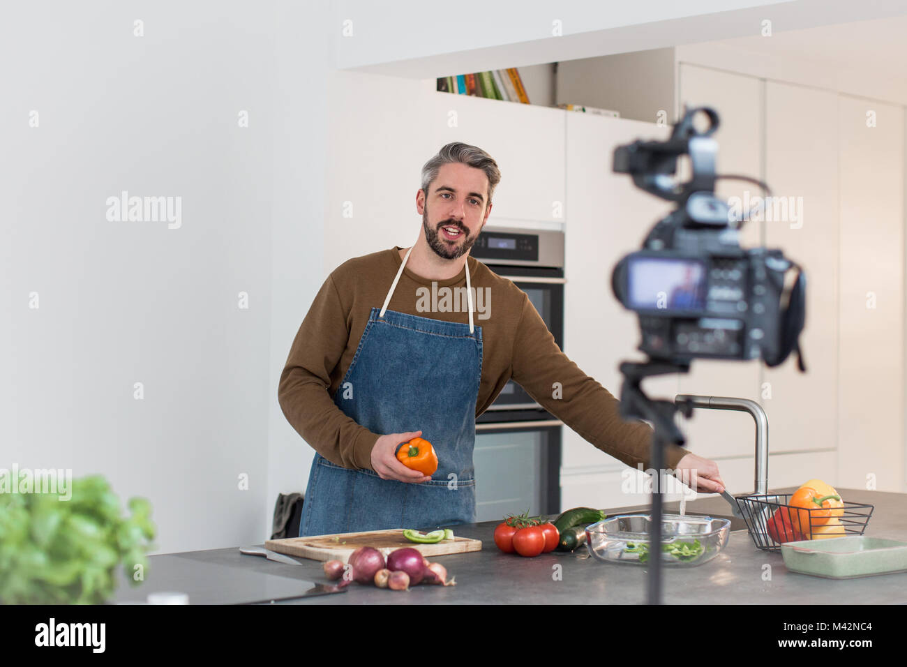 Adult male chef recording a video blog Stock Photo