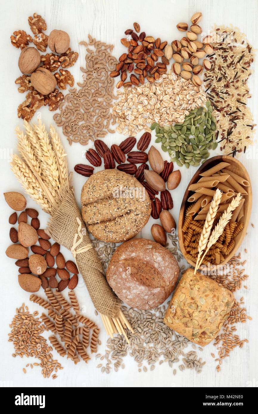 Food with high fibre content with whole grain bread rolls, whole wheat pasta, grains, nuts
