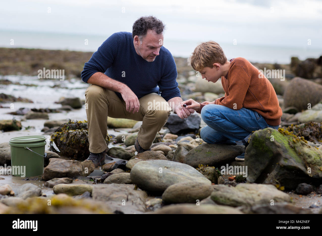 Father teaching Son how to fish Stock Photo - Alamy