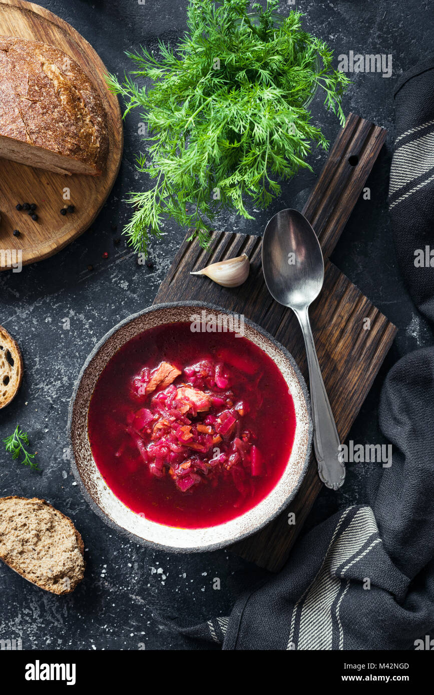 Beet soup Borscht in bowl on stone background. Top view, vertical composition Stock Photo