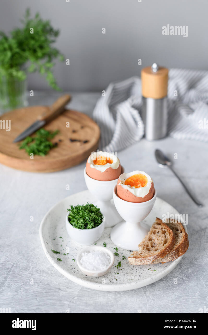 Soft boiled eggs and toasts for breakfast on cocnrete background. Selective focus. Healthy eating, healthy lifestyle concept Stock Photo