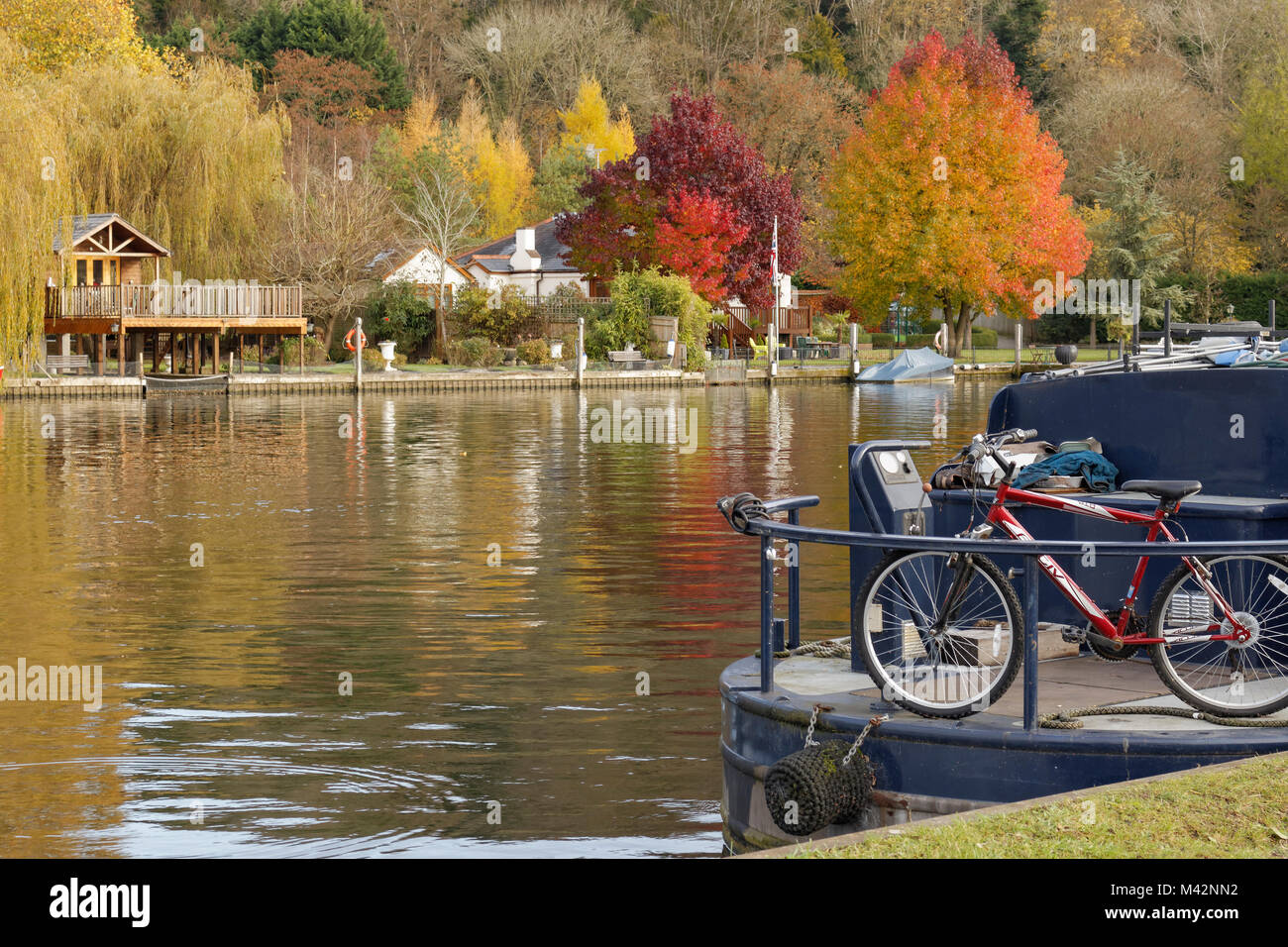 An image of a bicycle on the back of a narrow boat moored at Henley on Thames, Oxfordshire, England, UK Stock Photo