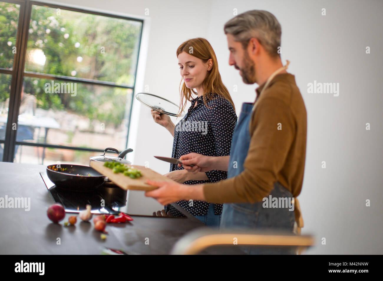 Couple preparing a meal together Stock Photo