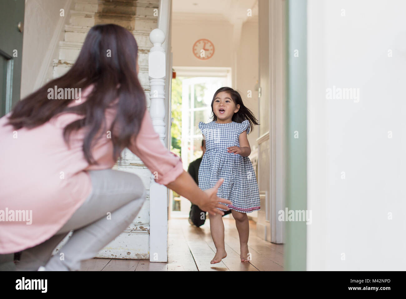 Girl running to welcome Mum home Stock Photo