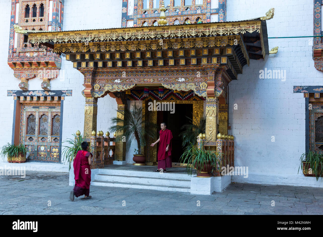 Punakha, Bhutan.  Buddhist Monks in Doorway of a Residential Area of the Punakha Dzong (Fortress/Monastery). Stock Photo