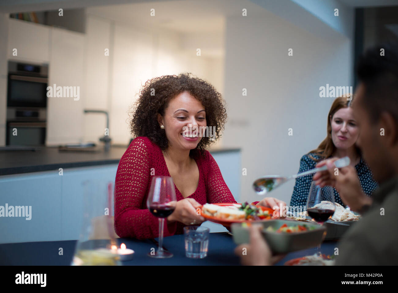 Adult male serving food to a friend Stock Photo