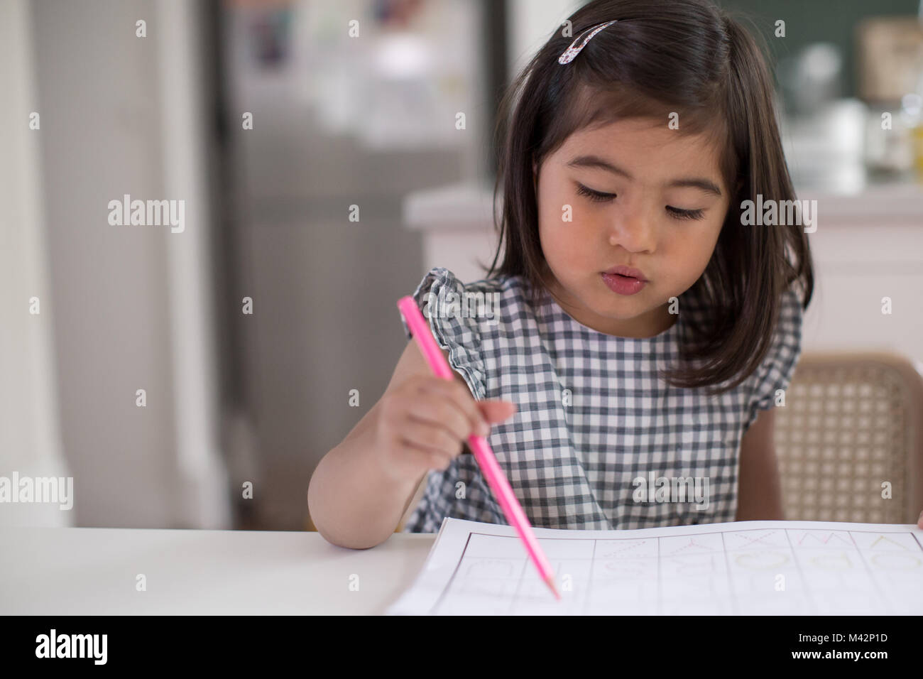 Girl learning how to write Stock Photo