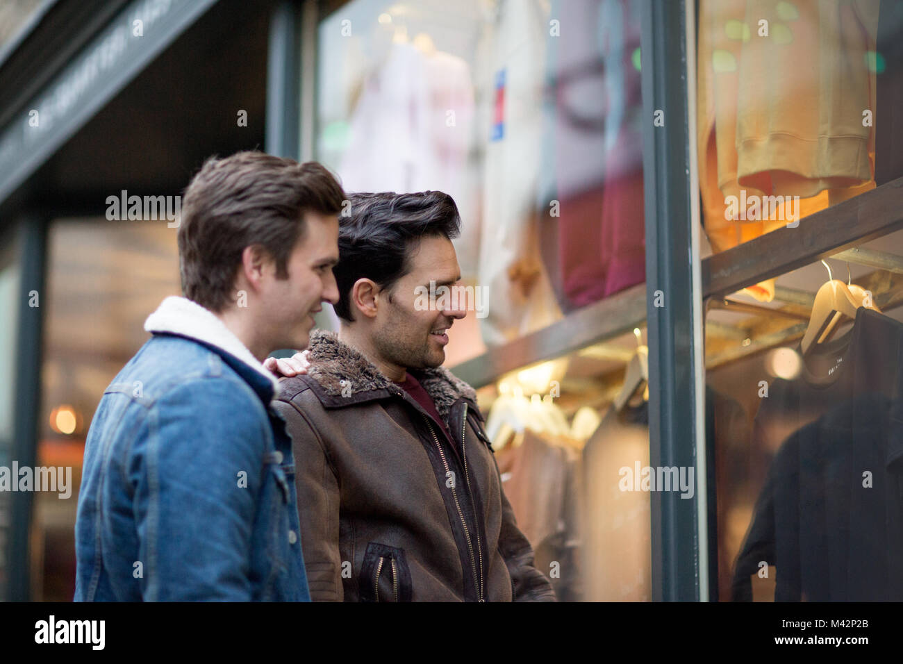 Young male couple window shopping Stock Photo