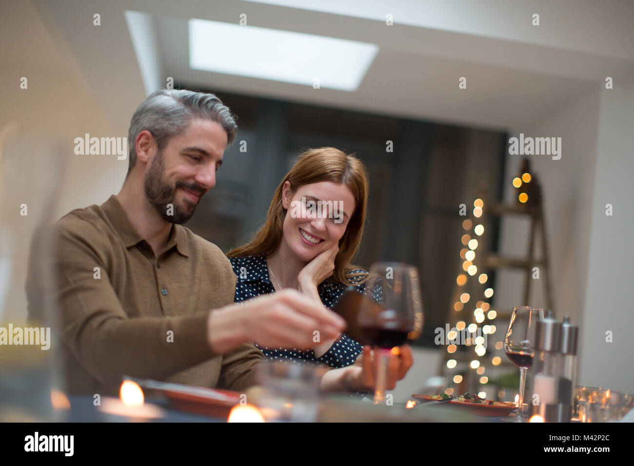 Couple looking at smartphone together at a meal Stock Photo