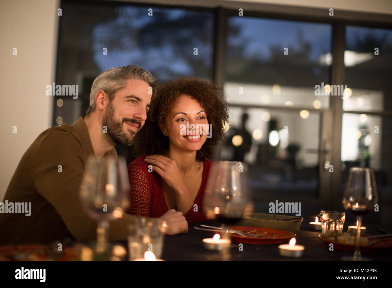 Multiracial couple having dinner with friends Stock Photo