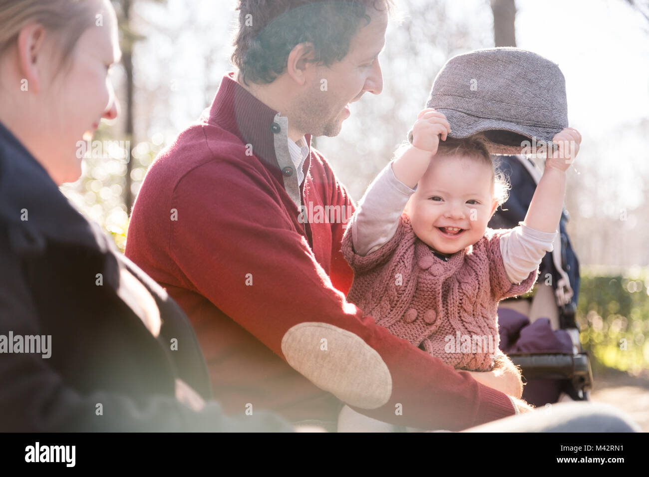 Young family with cheerful child in the park. Stock Photo
