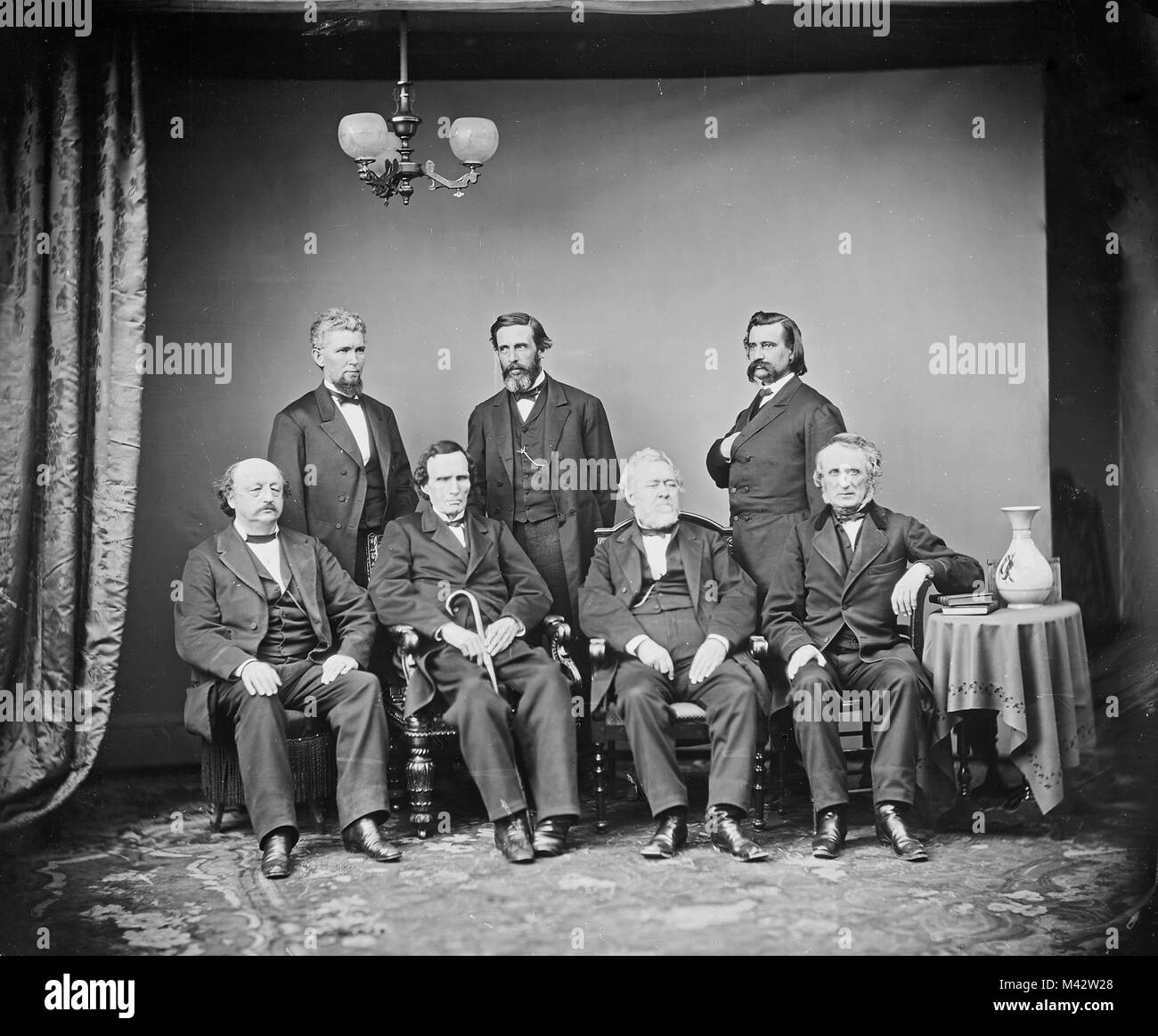 Johnson Impeachment Committee. Left to right, Seated: Benjamin F. Butler, Thaddeus Stevens, Thomas Williams, John A. Bingham. Standing: James F. Wilson, George S. Boutwell, John A. Logan. Stock Photo