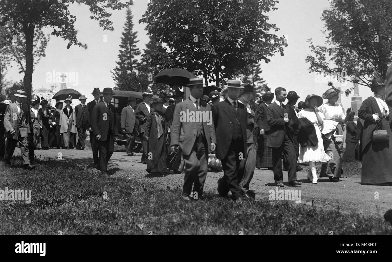 Mourners leave the cemetery after a funeral, ca. 1910. Stock Photo