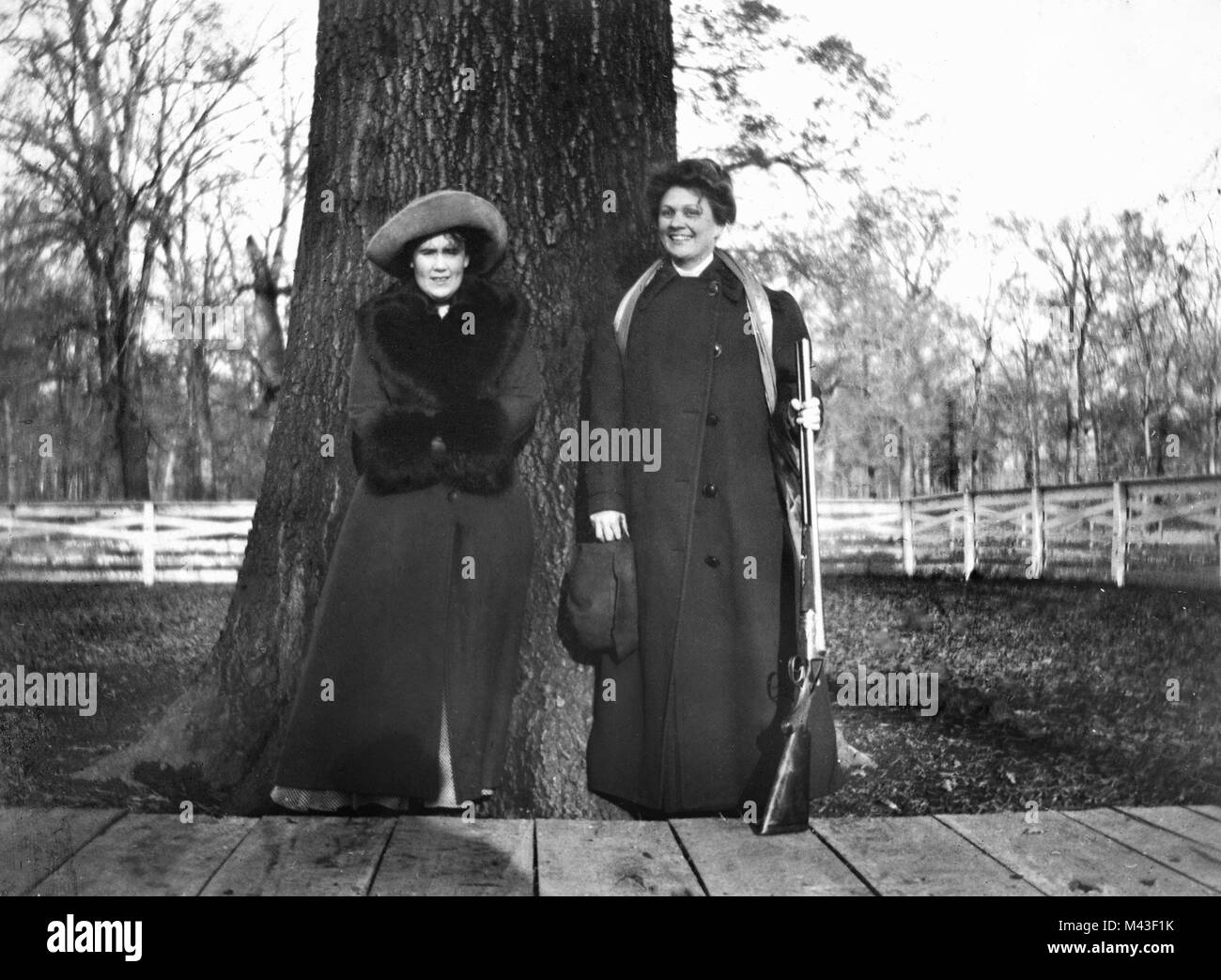 Two women and a shotgun pose, ca. 1930. Stock Photo