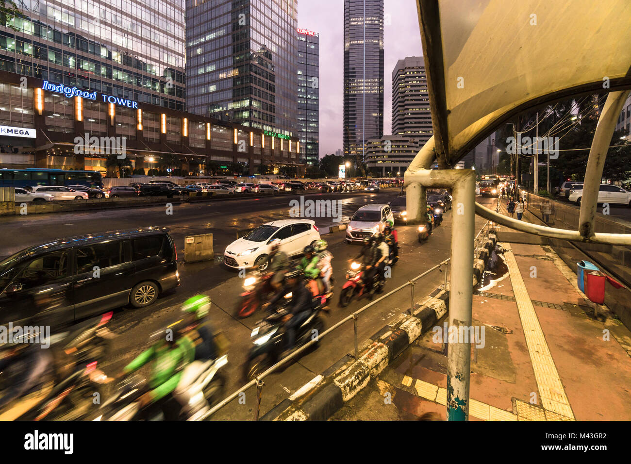 Jakarta, Indonesia - October 20 2017: Cars, buses motorcycles rushing on Sudirman street in Jakarta business district in Indonesia capital city at nig Stock Photo