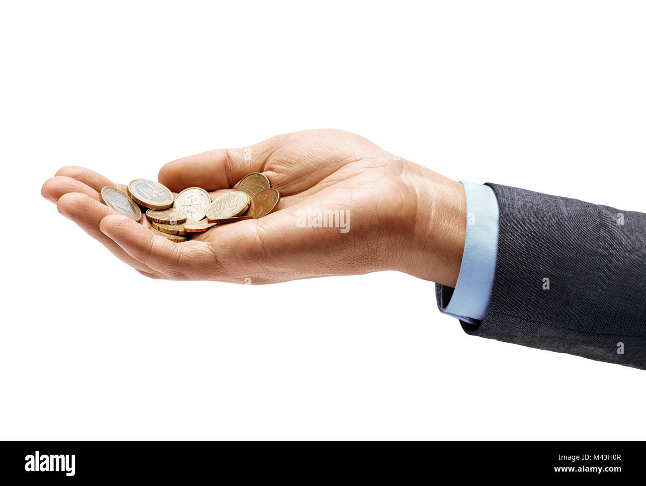 Man's hand in suit holding a heap of different coins isolated on white background. Close up. High resolution product. Business concept Stock Photo