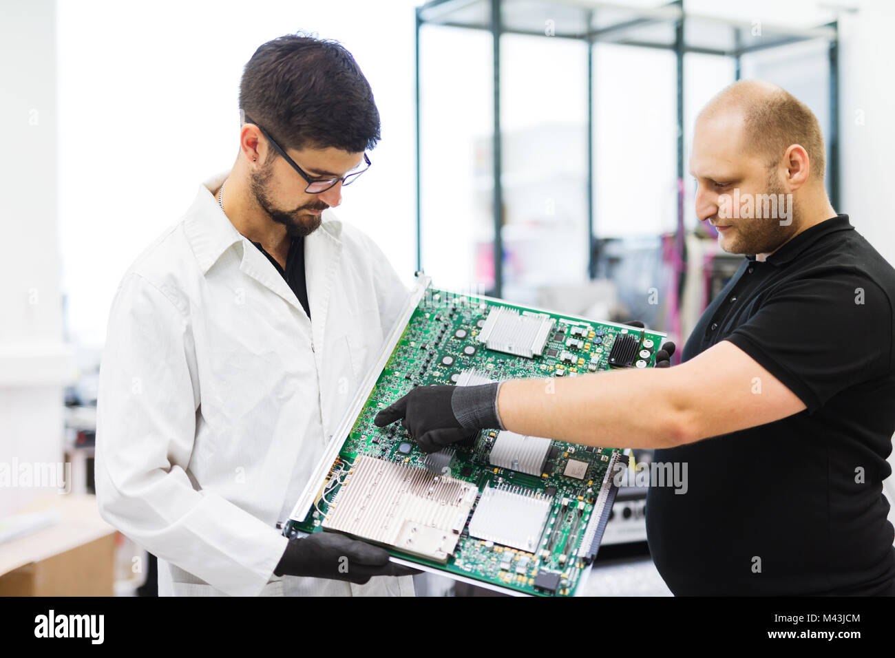 Portrait of young engineer holding CMTS card Stock Photo