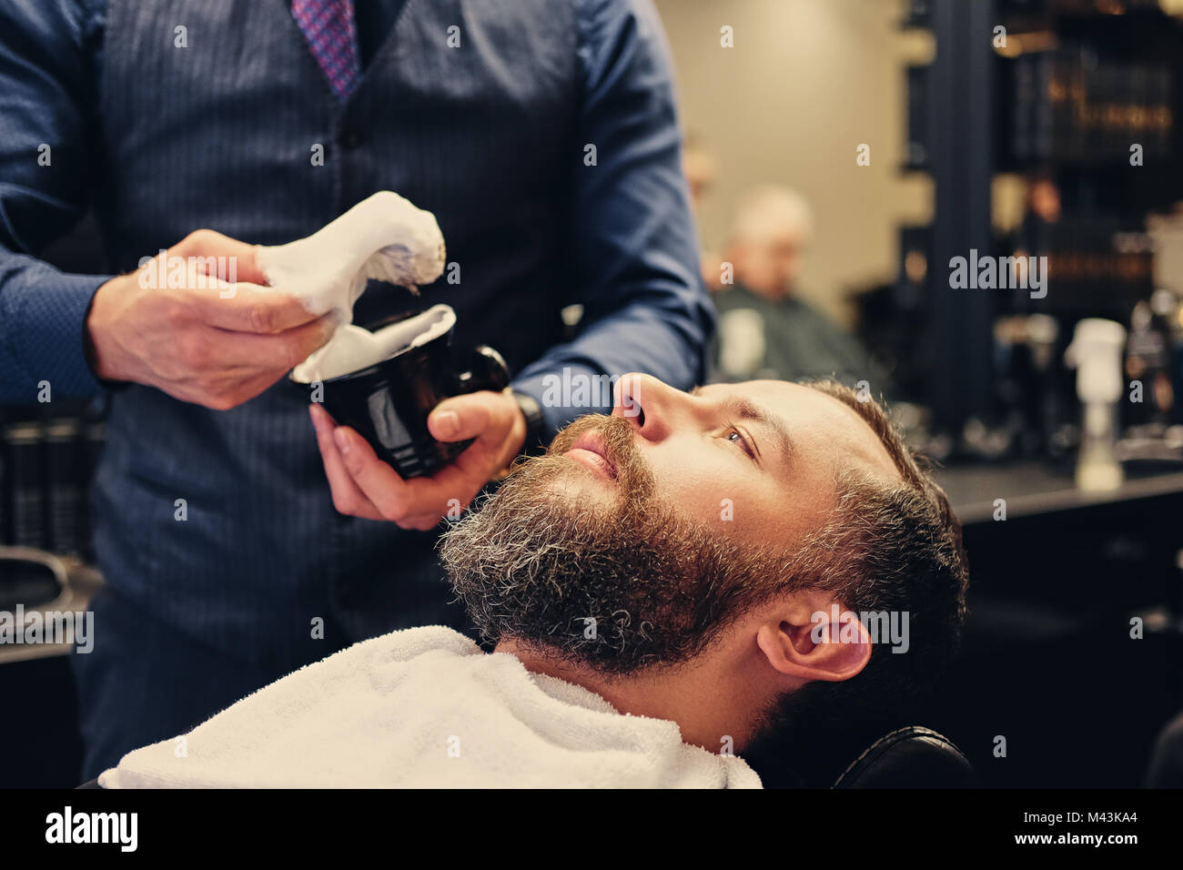 Barber applies shaving foam Stock Photo - Alamy