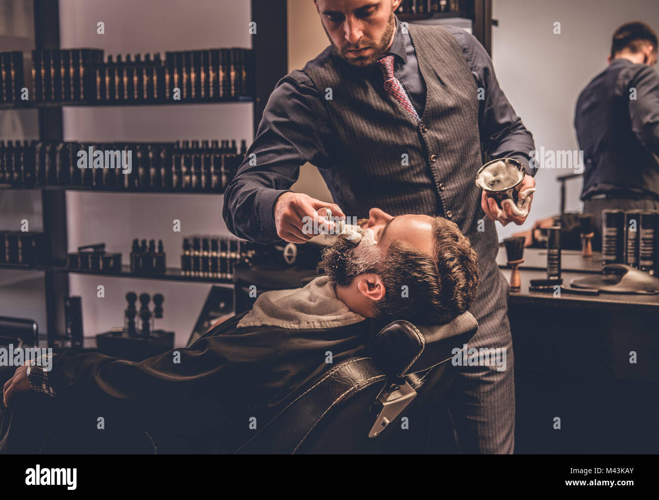 Barber applies shaving foam Stock Photo - Alamy