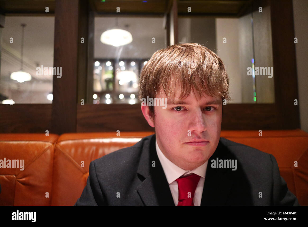 A serious stare into the camera from a suited man, or a smolder. Who knows. Stock Photo