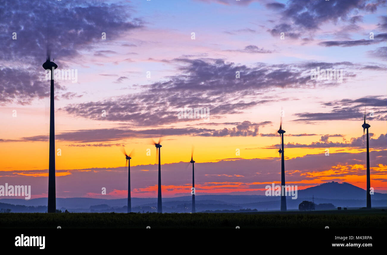 Wind engines at dawn seen in rural Germany Stock Photo
