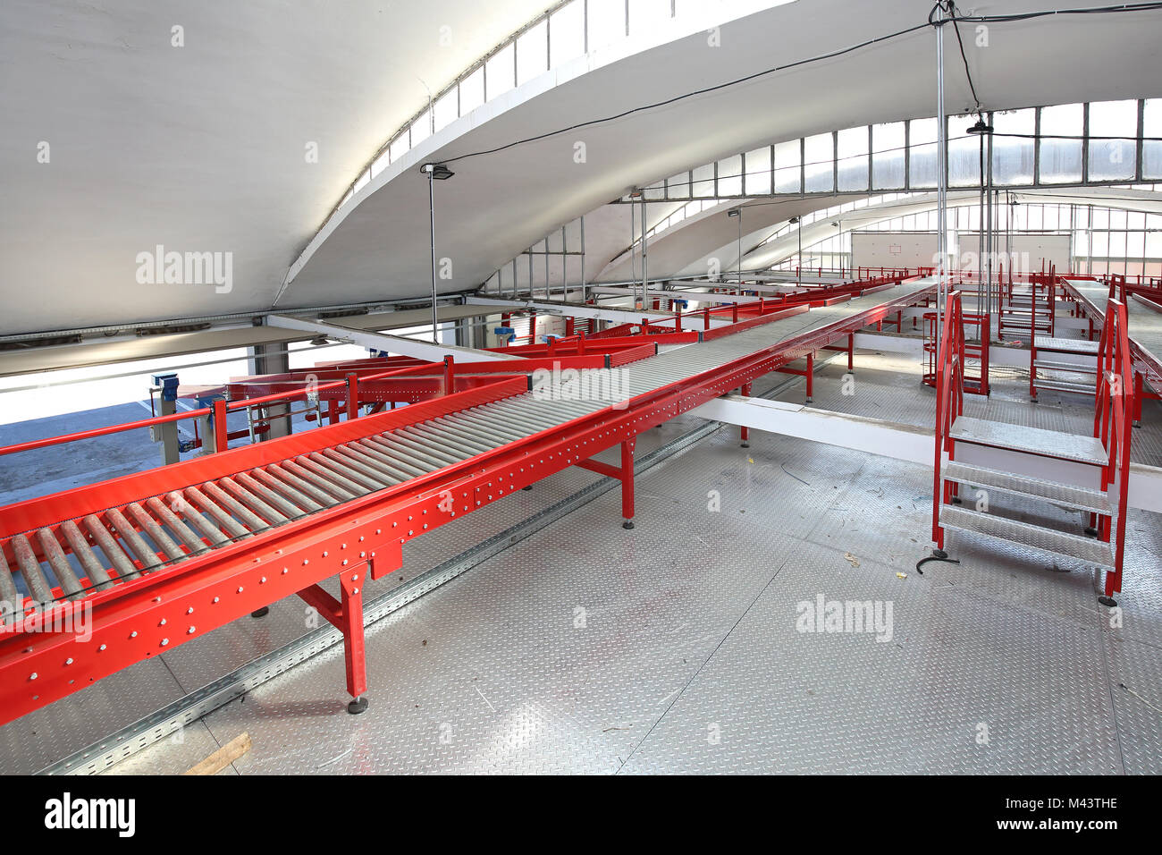 Long Conveyor Belt in Distribution and Delivery Warehouse Stock Photo