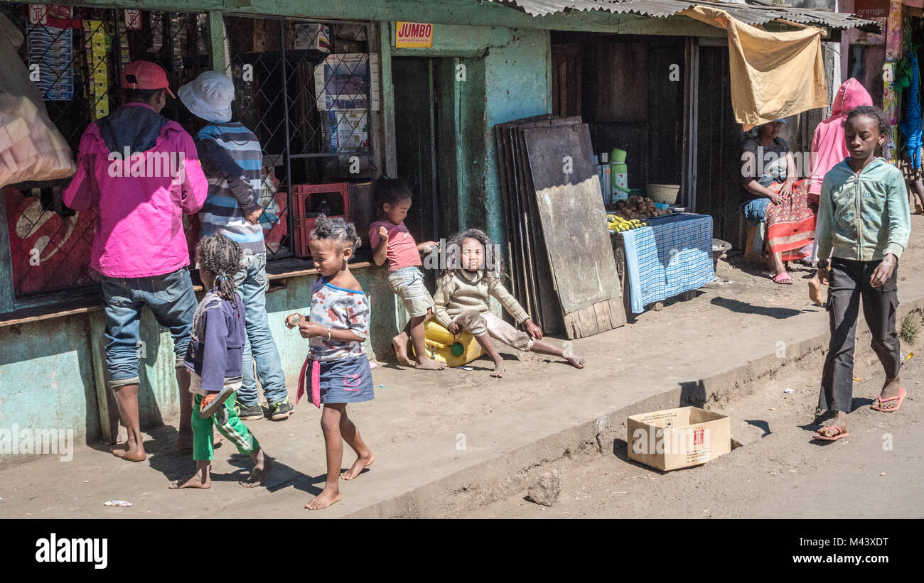 People Shopping and Sitting in Dirty Street, Madagascar Stock Photo