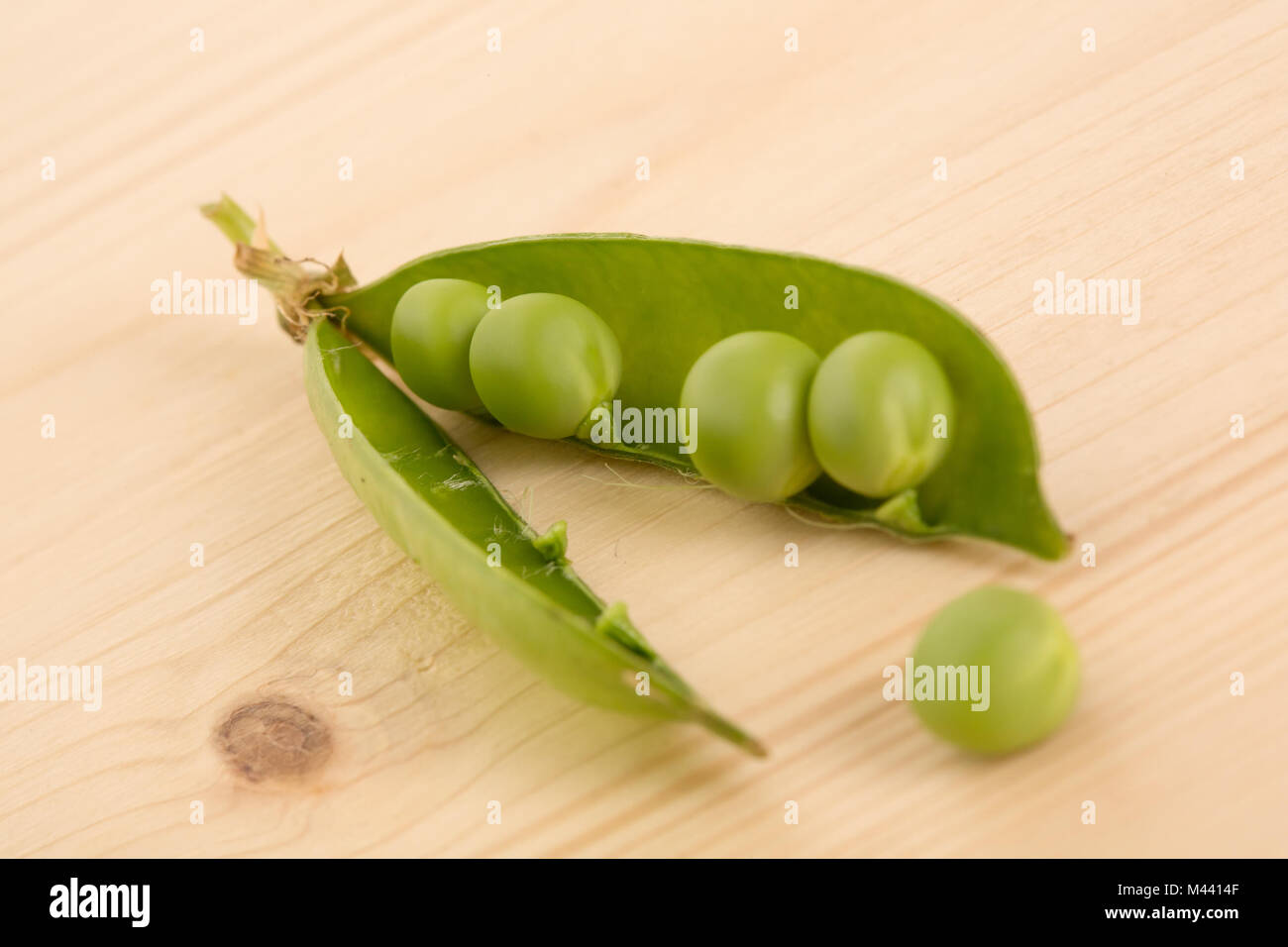 Fresh green peas on a wooden table Stock Photo
