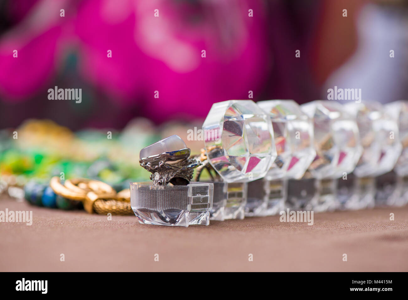 Engagement rings in boxes in a row on colorful background. Expensive