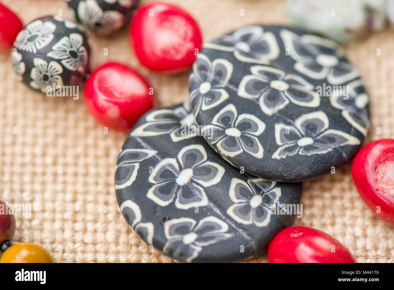 Earrings made of coral and acrylic stone. Shot of expensive gemstone