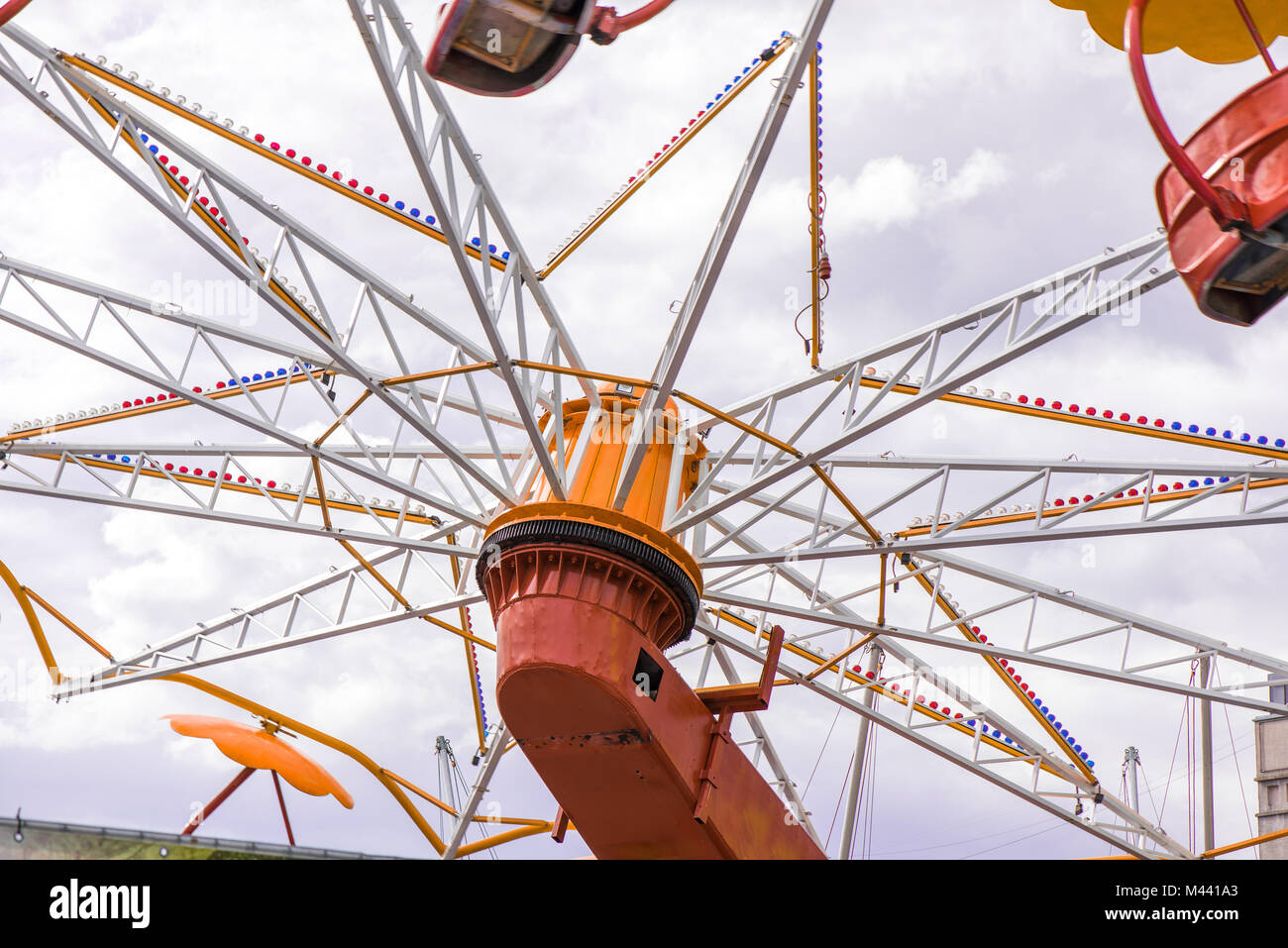 Colorful roller coaster seats at amusement park. People having fun in