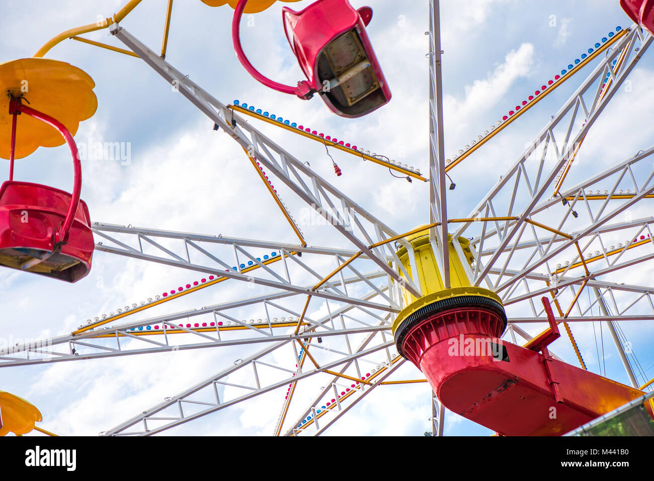Colorful roller coaster seats at amusement park. People having fun in
