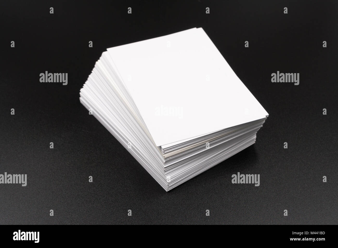 Stack of white cards. On a black background Stock Photo - Alamy