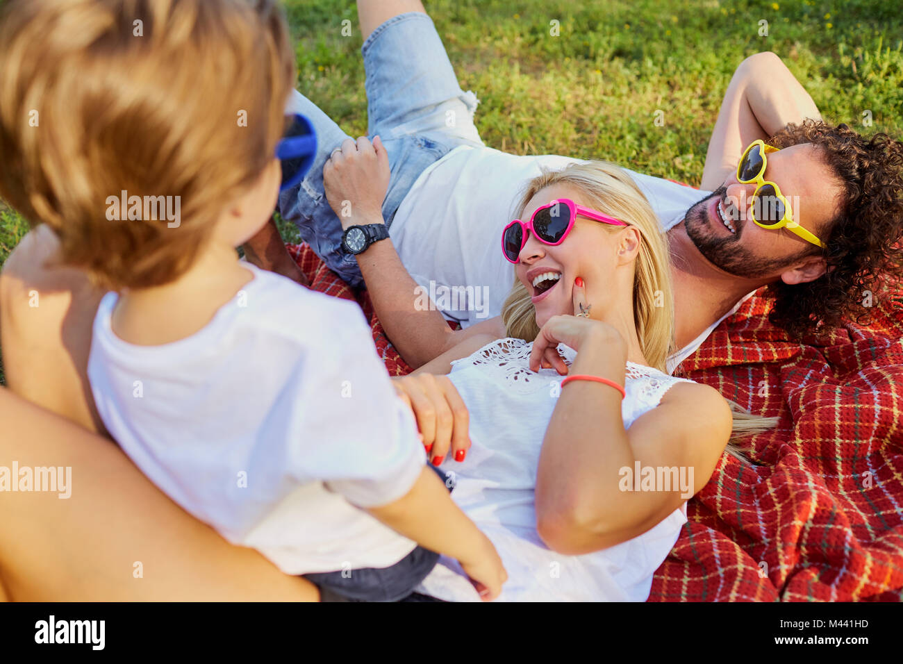 Happy family playing in the park Stock Photo - Alamy