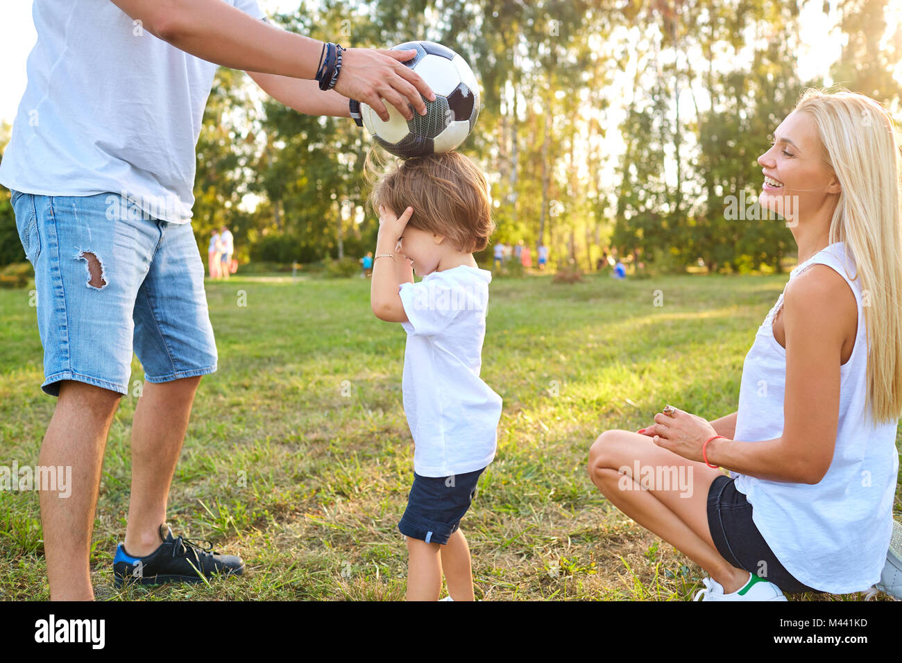 Family playing with a ball in the park Stock Photo - Alamy