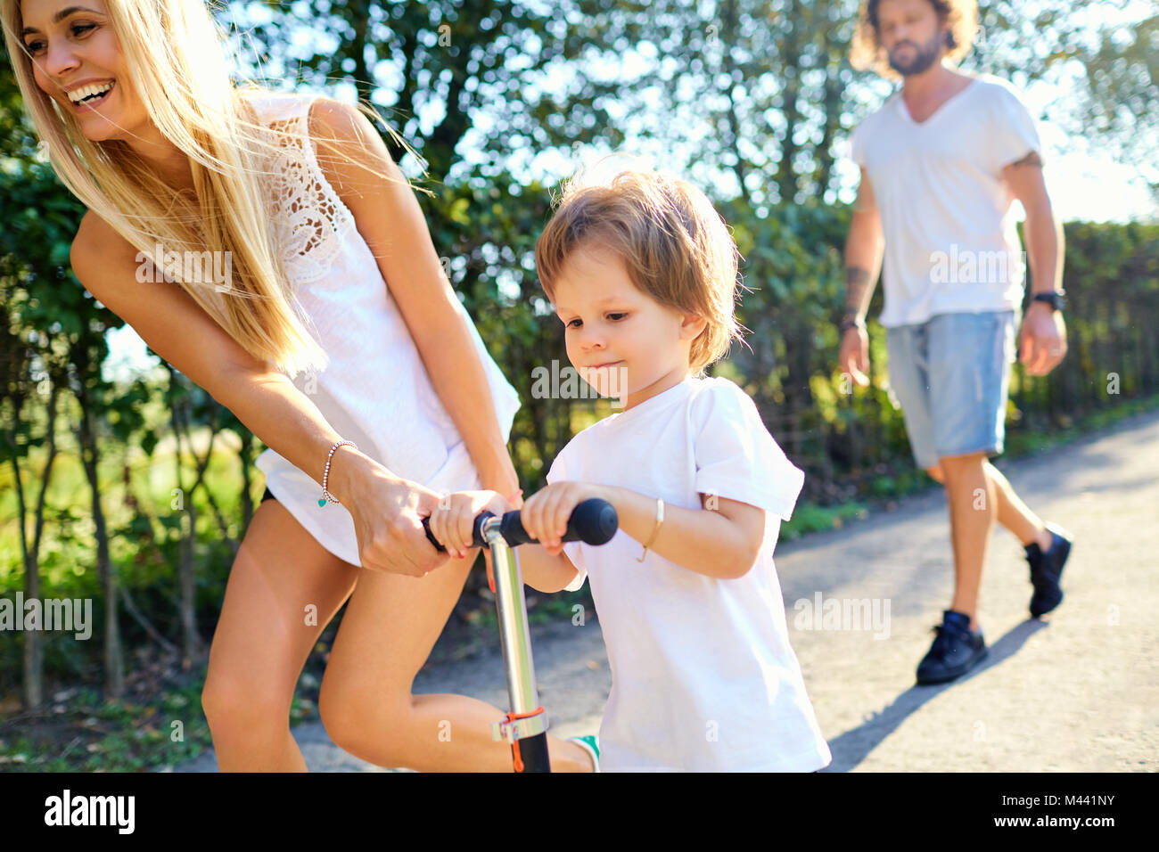 Happy family playing in the park Stock Photo - Alamy