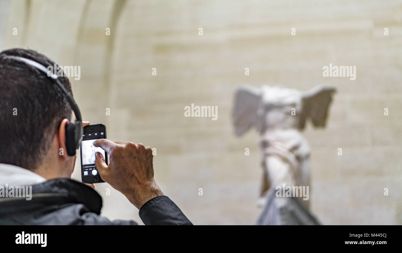PARIS - MAY 16: Unidentified tourist taking photos to Venus de Milo at the Louvre Museum on May 16 2015 Paris, France. Louvre is the biggest Museum in Paris Stock Photo