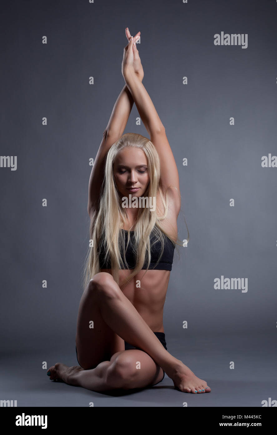 Image of becalmed blonde doing yoga in studio Stock Photo